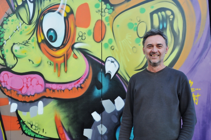 Tugomir Balog or 'Tugi Balog' in front of an artwork by artist KDC Mofor Space Monkey for May Lane Street Art Project. Photo by Felkiza Vinanda Marwoto. Taken on 14/5/2015.